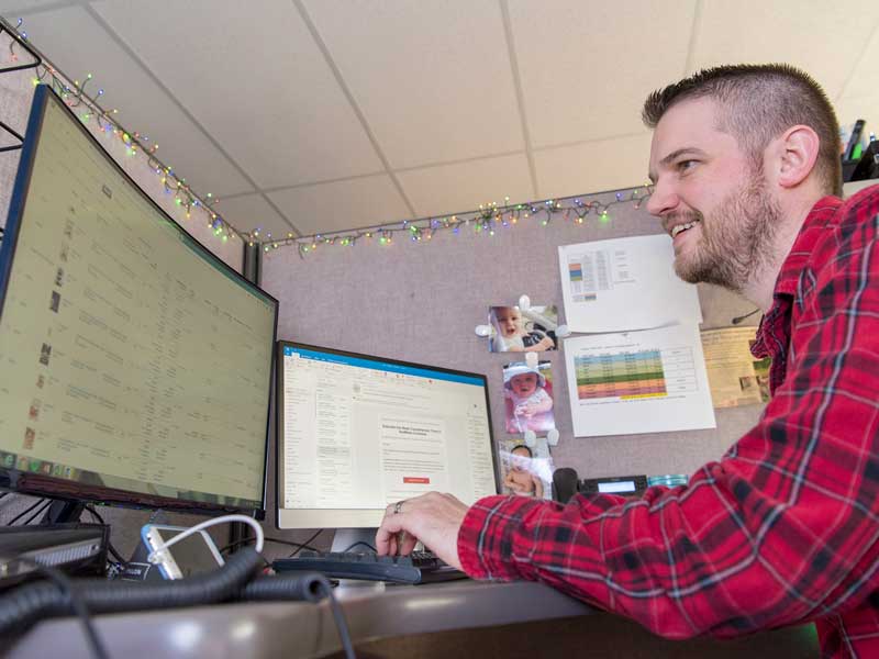 Employee smiling using computer